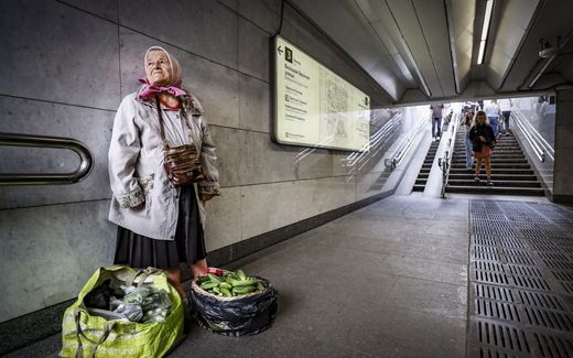 An elderly woman sells cucumbers on the Moscow metro. Photo EPA, Yuri Kochetkov