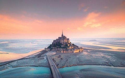 The tide plays with the sand around the island of Mont Saint-Michel off the coast of Normandy. Photo iStock
