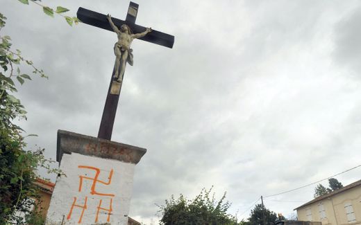 Vandalism on sacred places or objects is not unusual in Europe, like this swastica on a cross in France. Photo AFP, Alain Jocard