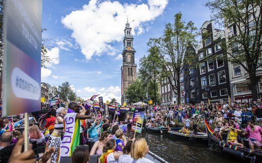 The canals in Amsterdam attracted thousands of visitors for the 25th edition of the Gay Pride event, last Saturday. The famous Westerchurch is in the background, along the Prinsengracht.  Photo ANP, Remko de Waal. 