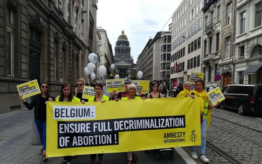 Protesters carry a banner of Amnesty International during a pro-abortion demonstration organised by the 'Collectif des 350", in Brussels. Photo AFP, Antony Gevaert
