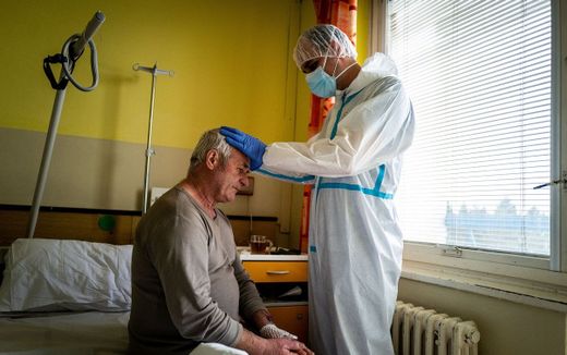 Priest blesses a patient in a Roman Catholic hospital. Photo AFP, Vladimir Simicek

