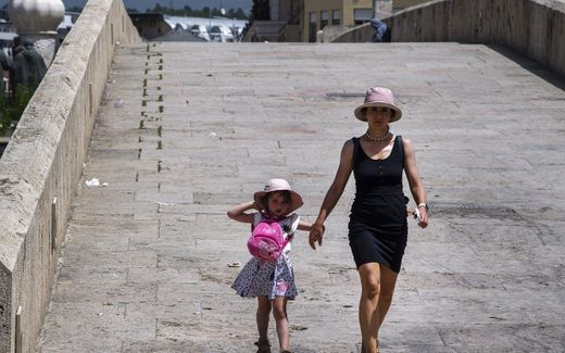 Mother and her child walk on an empty stone bridge during a hot day. Image is not related to the article. Photo EPA, Georgi Licovslki