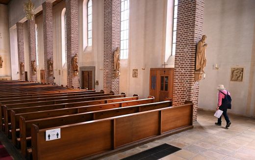 A woman walks past empty benches in a church in Starnberg, southern Germany.
Christof STACHE / AFP