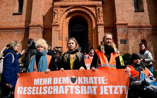 Activists of the environmental group "Last Generation" (Letzte Generation) line up for a march outside the Saint Thomas church in Berlin’s Kreuzberg district. Photo AFP, Tobias Schwarz