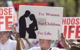 Protesters hold placards during a pro-life rally. Photo EPA, Glenn Hunt 
