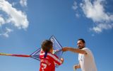 A father prepares to fly a kite with his son at Can Pere Antoni Beach in Palma de Mallorca. Photo AFP, Jaime Reina
