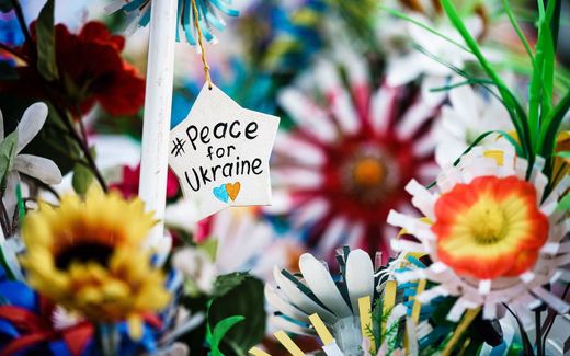  A Christmas star reading ‘# Peace for Ukraine’ hangs in between artificial flowers. The Orthodox Church of Ukraine moves further and further away from its Russian Orthodox roots. Switching from the Julian to the Gregorian calendar is a step in this process. Photo EPA, Clemens Bilan