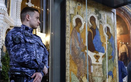 A Russian police officer stands guard near the icon 'Trinity' by Andrei Rublev during a church service on Holy Trinity in the Cathedral of Christ the Savior in Moscow. Photo EPA, Sergei Ilnitsky