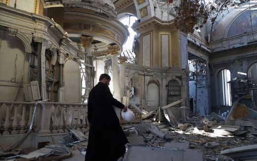 A priest examines the damages after the destruction of the Transfiguration Cathedral building as a result of a missile strike in Odesa. Photo AFP, Oleksandr Gimanov