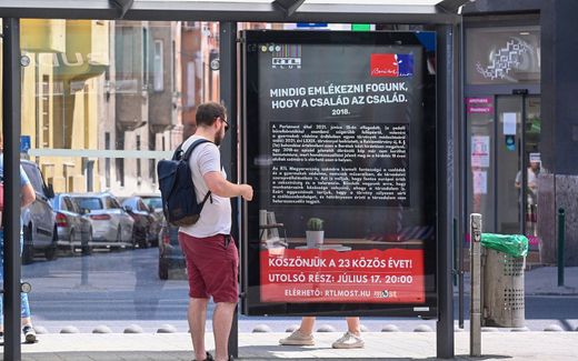 A man reads the text on a poster of TV station RTL Klub, which previously featured a photo of a gay wedding from one of their shows. It has being removed and replaced with text, due to the new law banning the "display or promotion" of homosexuality. Photo AFP, Attila Kisbenedek
