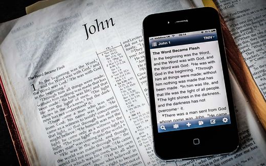 Paper or screen? The message is the same; the experience is different. Photo Digital Bible; Techbuild Africa