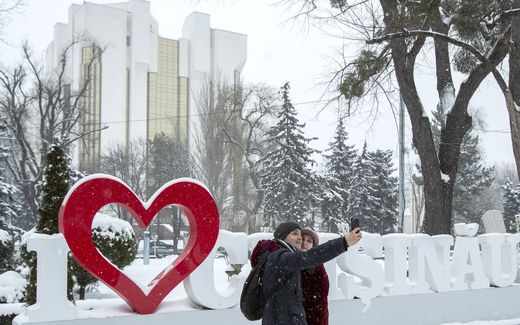 A couple takes a photo in Chisinau, the capital of Moldova. The Orthodox Church in the country is worried about the direction regarding marriage taken by Western Europe. The church leadership says the majority of the country is for traditional marriage. Photo EPA, Dumitri Doru
