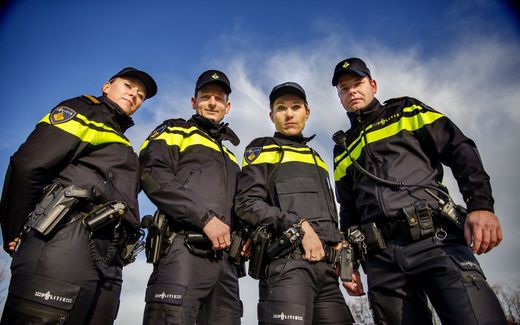 Dutch police officers wearing their uniform. According to the Dutch Justice Minister, all officers must look the same when doing their work on the streets. ANP, Jerry Lampen