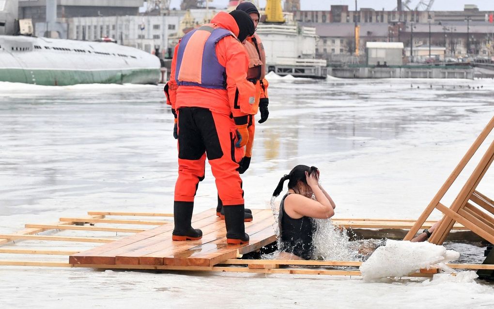 Eastern Orthodox believers brave cold for traditional dive  