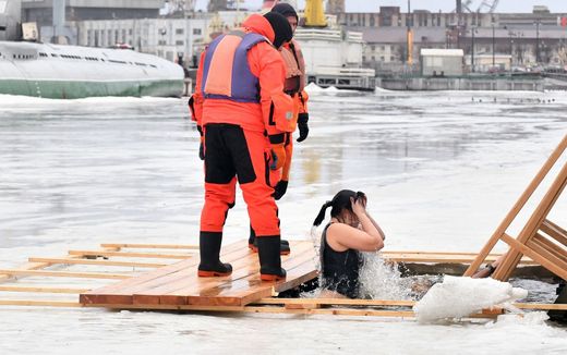An Orthodox believer plunges into the icy water of Neva river during the traditional Epiphany celebrations in Saint Petersburg, on January 19, 2023. Photo AFP, Olga Maltseva