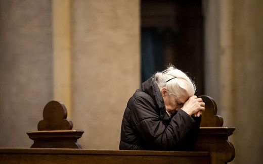 A churchgoer praying in a Roman Catholic Cathedral in the Dutch town of Roermond. Photo ANP, Sem van der Wal 