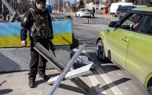A volunteer looks at a motorist as he takes position at a checkpoint in a district in Kyiv. Photo AFP, Fadel Senna
