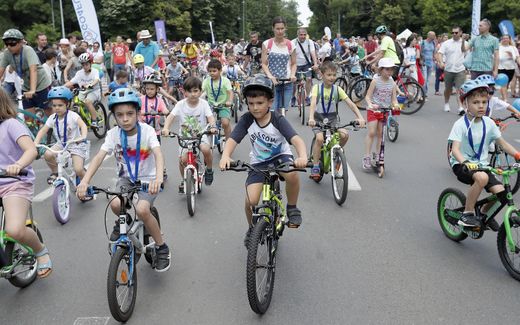 Children assisted by their parents and volunteers take part in the Little Cyclists Parade during the International Children's Day in downtown Bucharest, Romania. Photo EPA, Robert Ghement
