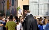 A priest spreads holy water to bless pupils on the first day of the 2023-24 academic year. In Greece, education and the Greek Orthodox Church are closely connected. Photo EPA, Vasilis Psomas