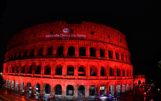 The redly illuminated colosseum. Photo Church in Need