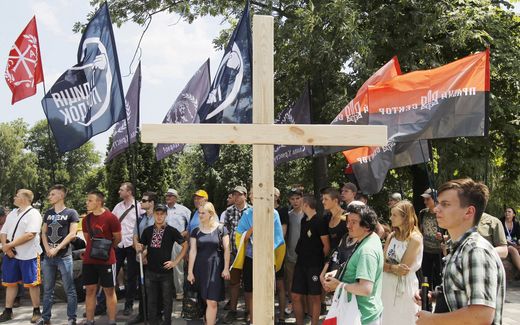 Anti-LGBT protesters hold flags and stand next to a cross, during a rally against a gay parade in downtown Kiev, Ukraine. Photo EPA, Stepan Franko