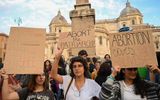 People hold placards as they take part in gathering to mark the annual International Safe Abortion Day, on September 28, 2022 in downtown Rome. Photo AFP, Alberto Pizzoli
