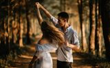 Couple dancing in the forest. Photo Unsplash, Scott Broome
