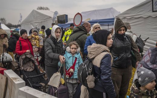 Ukrainian evacuees queue as they wait for further transport at the Medyka border crossing. Photo AFP, Angelos Tzortzinis 