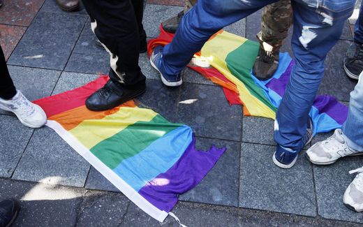 Anti-LGBT activists trample a LGBT flag. Photo EPA, Stephan Franko 