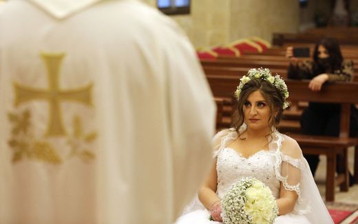 A Roman Catholic priest performing a wedding ceremony. Photo AFP, Anwar Amro

