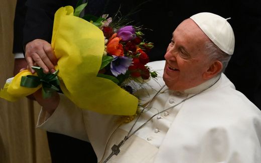 Pope Francis is handed a bunch of flowers during the weekly general audience at Paul-VI hall in The Vatican. Photo AFP, Vincenzo Pinto
