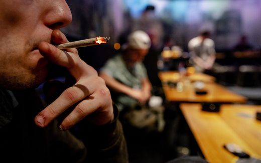 A man smoking weed in a coffeeshop. Photo ANP, Robin van Lonkhuijsen


