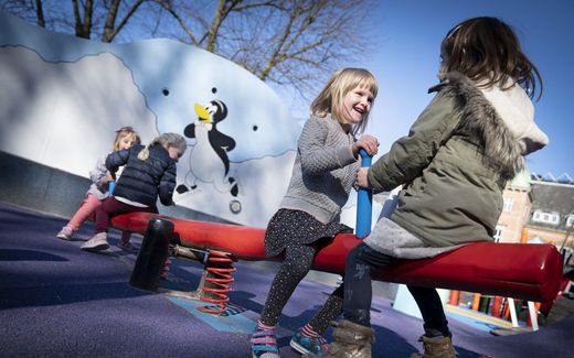 Children play on a playground. Often they do not feel any hesitation to start a conversation with other kids and play together. Photo AFP, Liselotte Sabroe
