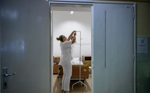 A healthcare professional prepares an infusion at a hospice department of a hospital in Hungary. Photo EPA, Peter Komka