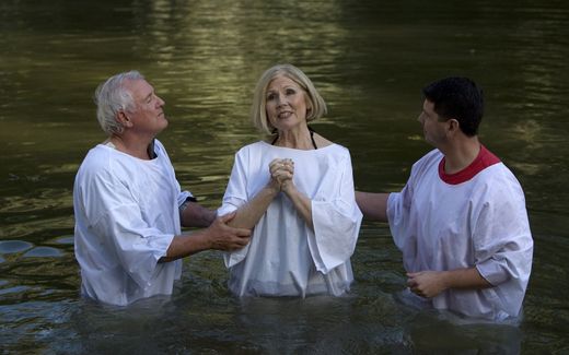Christian believer is baptised by immersion. Photo AFP, Ahmad Gharabli

