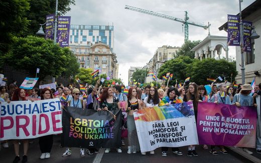 People hold banners and wave Rainbow flags as they take part in the Pride Parade in Bucharest. Photo AFP, Ilona Andrei 