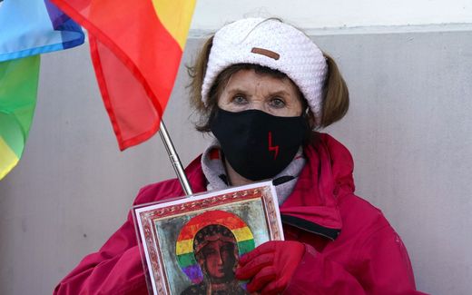 Protestor with an image of the Virgin Mary with rainbow colours. She protests against the trial of LGBT activists accused of blasphemy for adding a rainbow to an image of the Mother of Jesus. Photo AFP, Janek Skarzynski