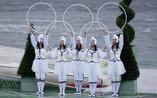 Performers hold up hoops in the shape of the Olympic rings on a floating platform on the river Seine during the opening ceremony. Photo AFP, Stefan Wermuth