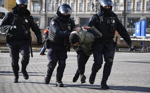 Russian police detaining a man. Photo AFP