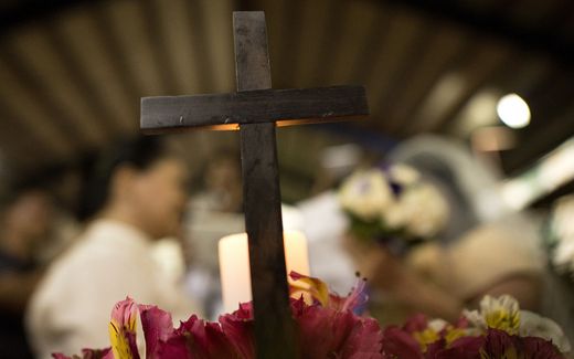A Christian cross is pictured as couples from the lesbian, gay, bisexual and transgender (LGBT) community take part in a "Rite of Holy Union" ceremony. Photo AFP, Noel Celis