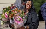 Newly appointed Norwegian Ministry of Culture and Equality, Lubna Jaffery smiles after the key handover in Oslo on Wednesday. She was overloaded with flowers. Photo EPA, Martin Solhaug Standal 
