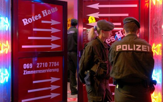 Police stand outside a brothel in Frankfurt's red light district during a search of several brothels on suspicion of forced prostitution. Photo EPA, Werner Baum