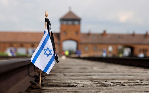 A small national flag of Israel has been placed on the rail tracks at the site of the former Auschwitz-Birkenau camp during commemorations to honour the victims of the Holocaust. Photo AFP, Wojtek Radwanski
