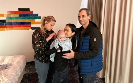 Two parents pick up their baby born via a surrogate mother. Image not related to content. Photo AFP, Dynamo