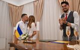 Vitaliy Charnykh (R), 21-years-old, conducts a wedding ceremony at a registery office in Kyiv. Photo AFP, Sergei Supinsky