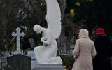Visitors walk past an angel figure on a grave at the 'Alter Domfriedhof St Hedwig’ cemetery in Berlin. Photo AFP, Tobias Schwarz