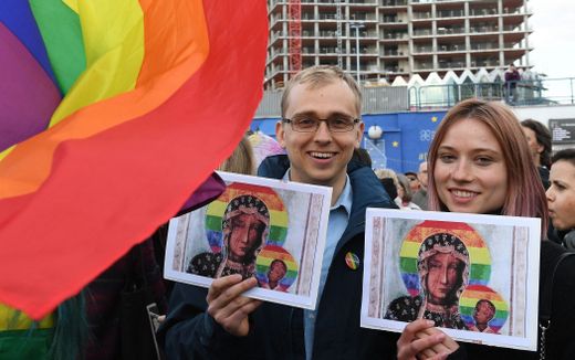 Protester hold rainbow flags and posters depicting the Virgin Mary with a rainbow halo during a rally for freedom of speech in downtown Warsaw. Photo AFP, Janek Skarzynski

