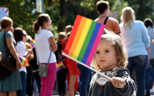 Child holds the rainbow flag during a Pride march in Podgorica, Montenegro. Photo EPA, Boris Pejovic
