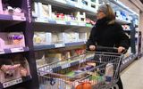 A shopper passes cheese at a supermarket. Photo EPA, Neil Hall